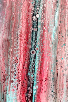 Colorful abstract fluid painting featuring intricate cell patterns in pinks and blues.