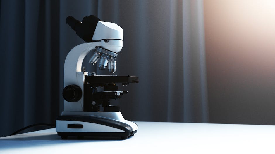 Close-up of a modern microscope in a laboratory with soft lighting.